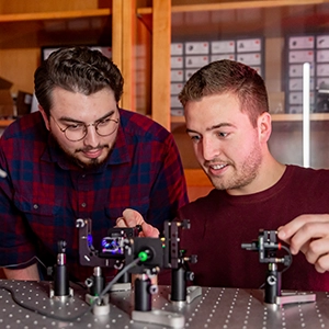 two male students experiment physics